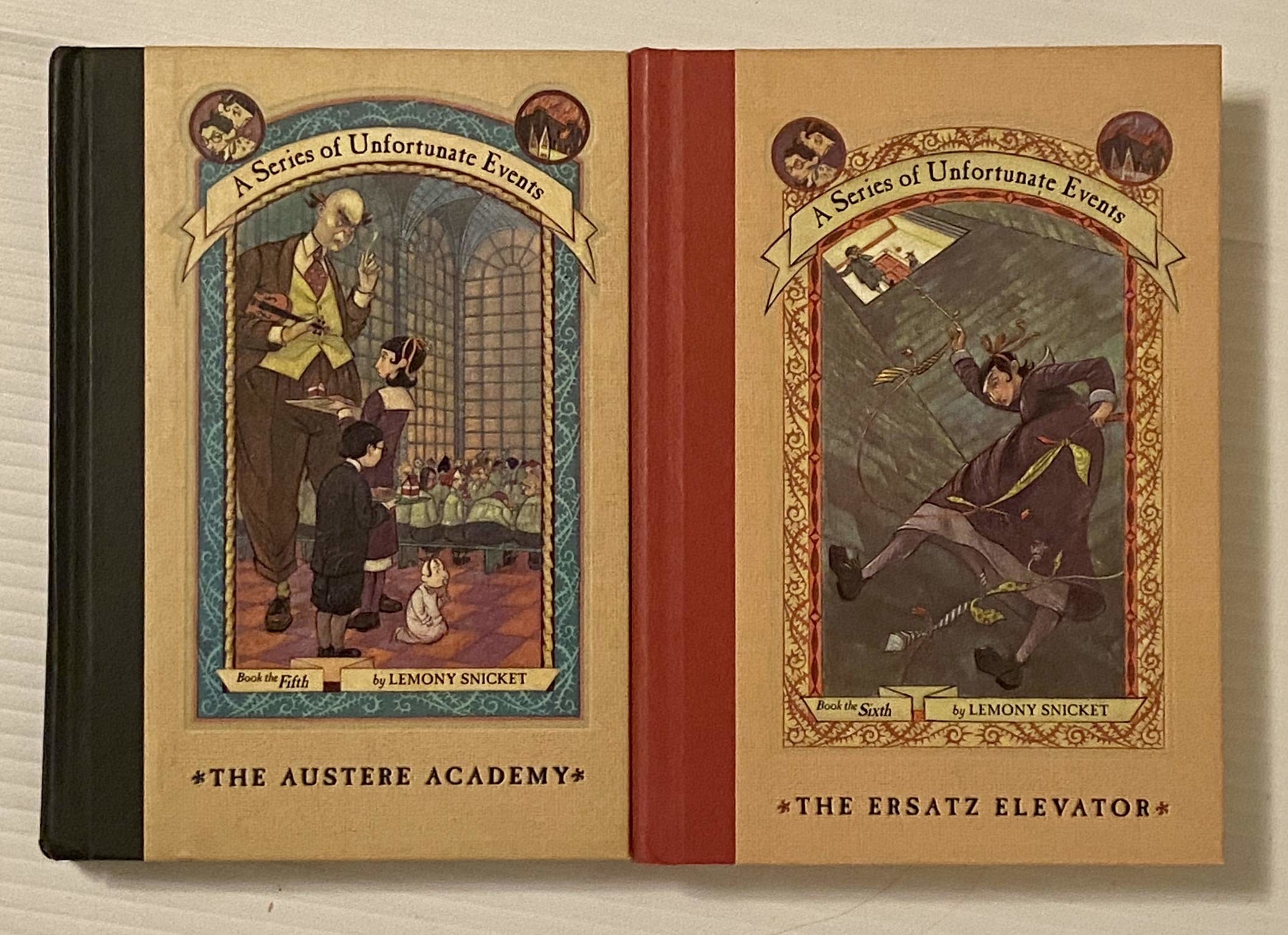 Two Series of Unfortunate Events books side by side. One with green spine, one red