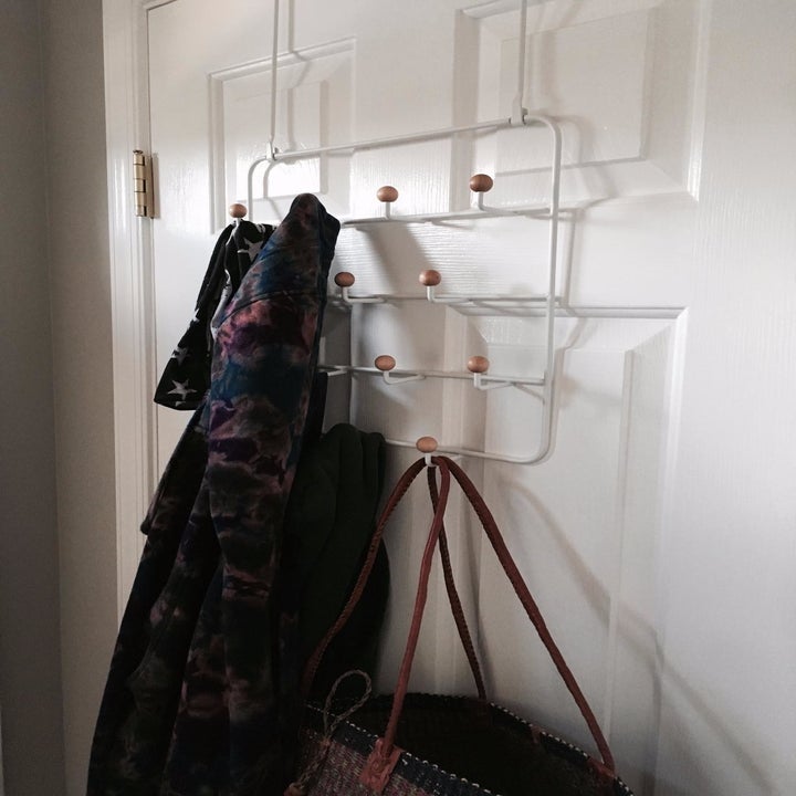 reviewer image of scarves and bags hanging from the umbra over-the-door organizer