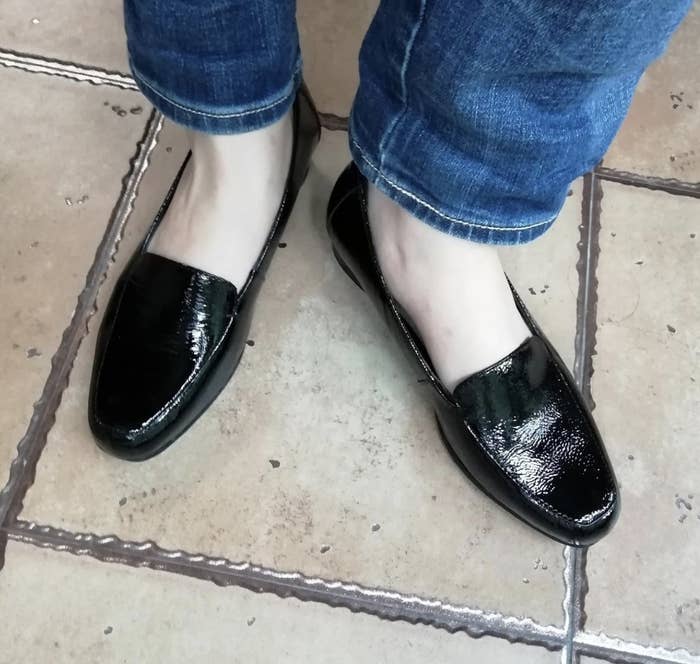 a person wearing the shoes in patent leather