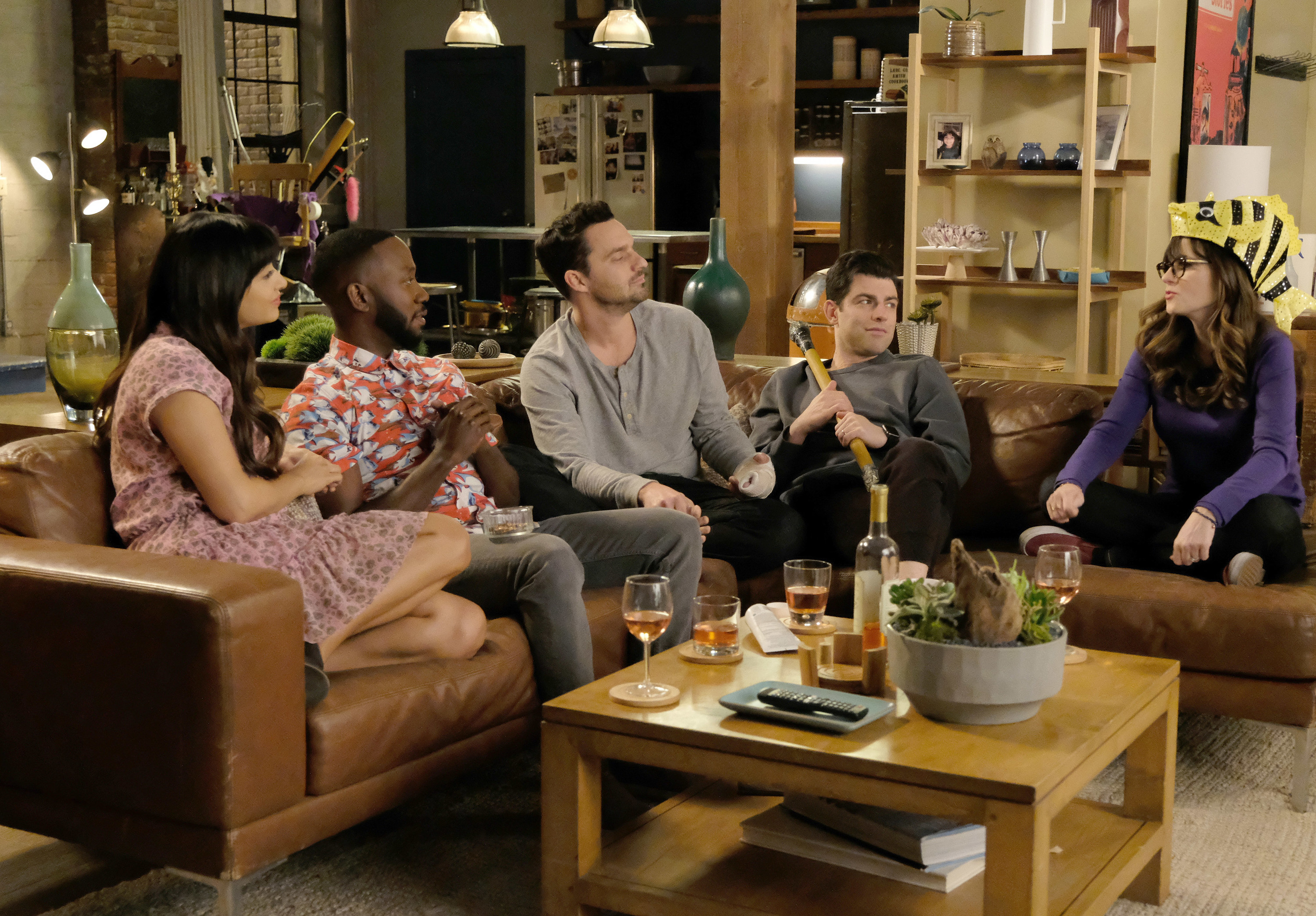 Hannah Simone, Lamorne Morris, Jake Johnson, Max Greenfield, and Zooey Deschanel sitting on the couch with glasses of wine in front of them as Cece, Winston, Nick, Schmidt, and Jess on &quot;New Girl&quot;