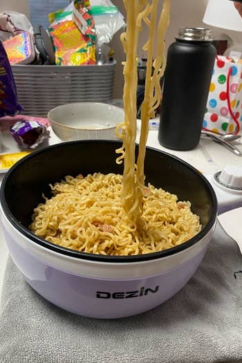 a reviewer photo of someone spooning noodles out of the pot 