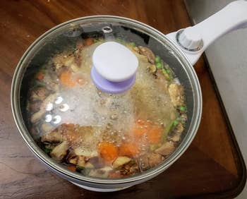 a reviewer photo of the pot filled with food with the lid on 