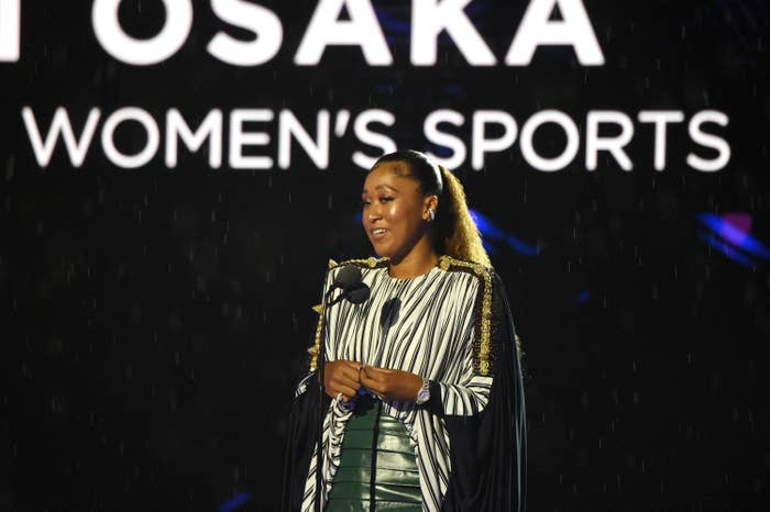 Naomi Osaka onstage and speaking into a microphone