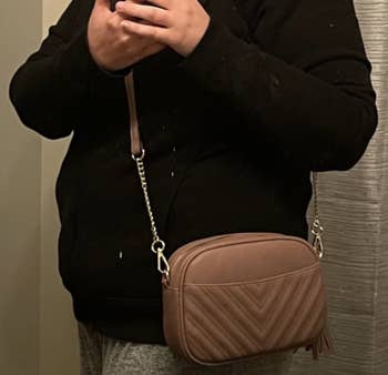 reviewer with it worn cross body style