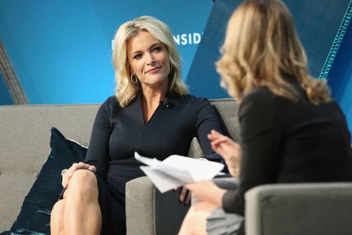 Megyn Kelly sitting on a couch and smiling at another woman