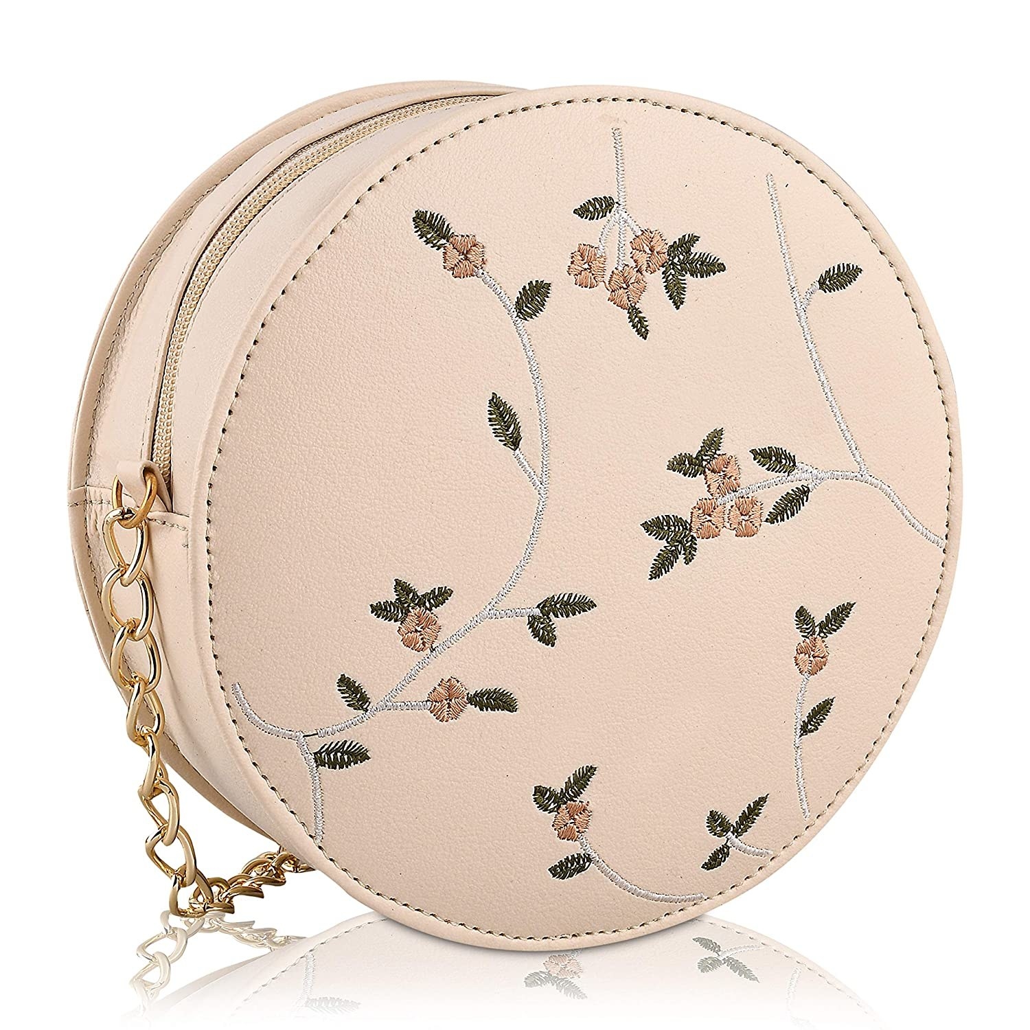 A round beige sling bag with floral embroidery and metal chain strap in gold