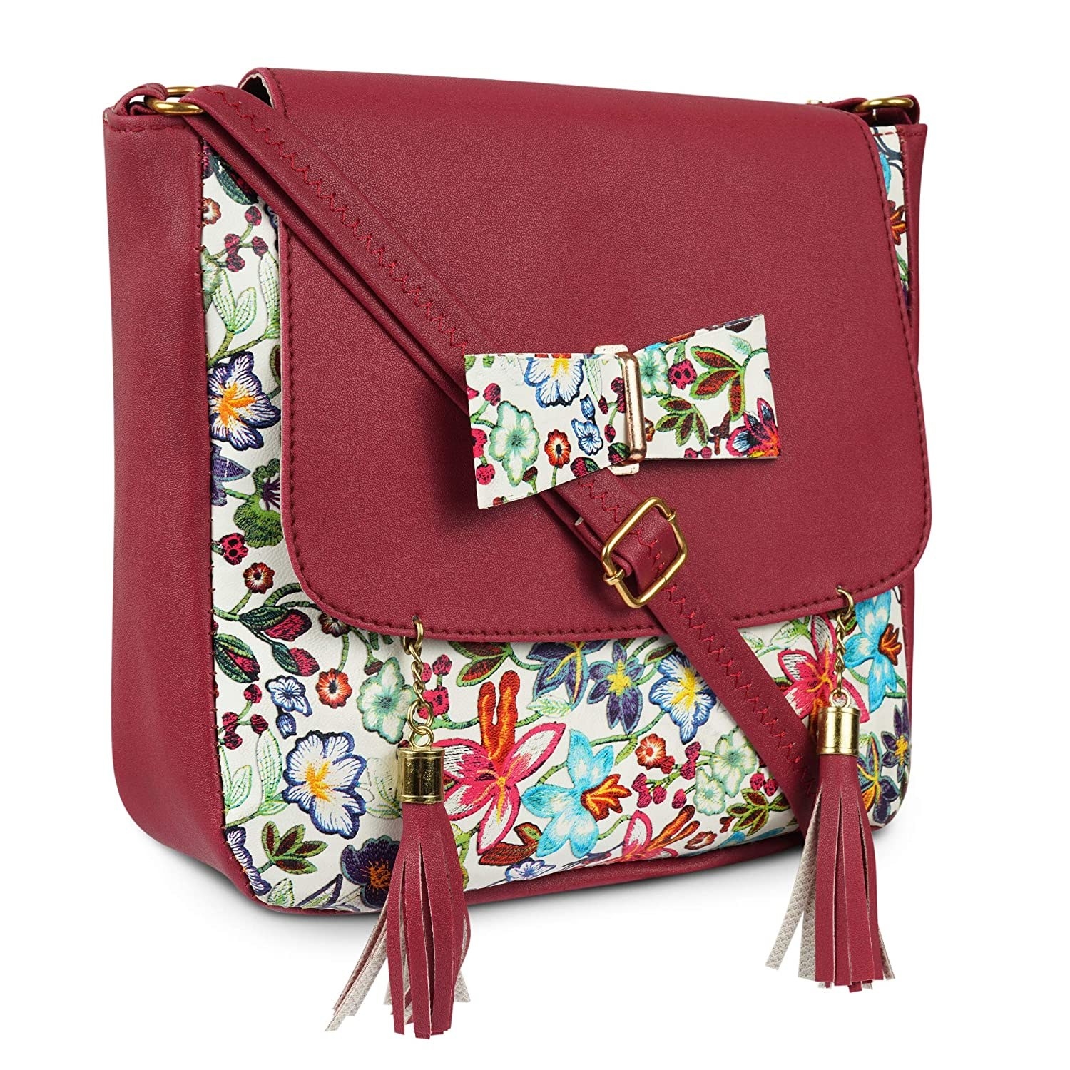 A dual-toned sling bag with red and floral prints having two tassels and one bow on it