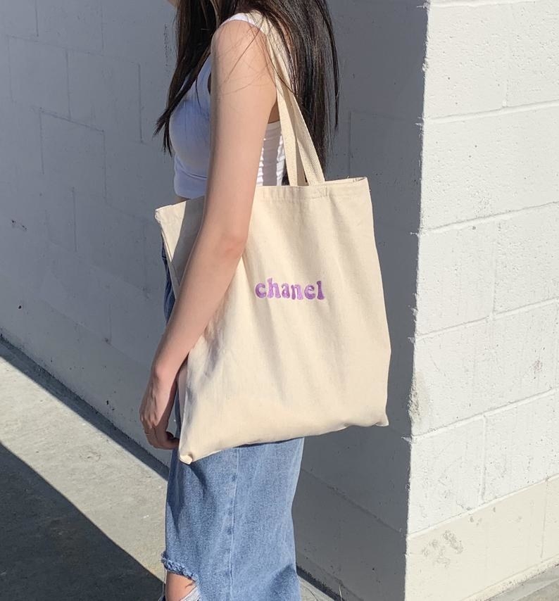Model wearing personalized tote bag outside