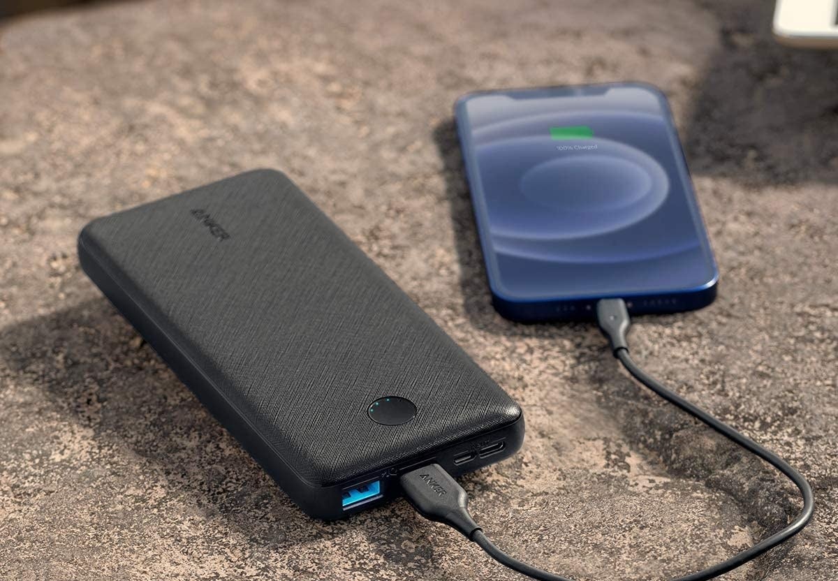 black portable charger charging an iphone