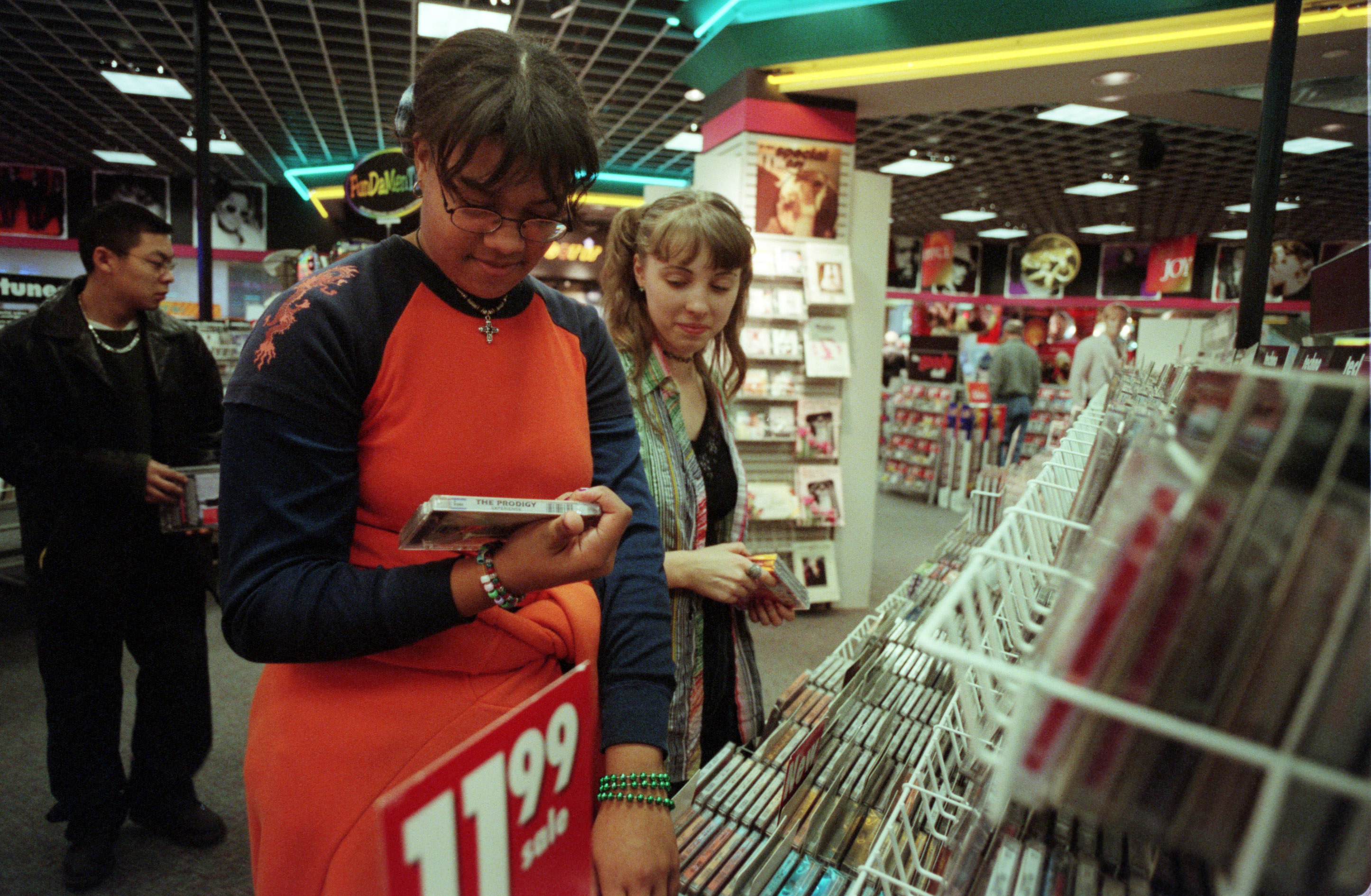 Photo of two kids looking at a CD in a Sam Goody&#x27;s