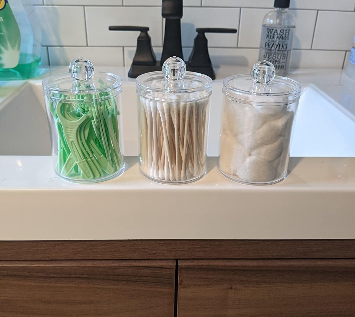 the three clear jars filled with flossers, Q-tips, and cotton balls