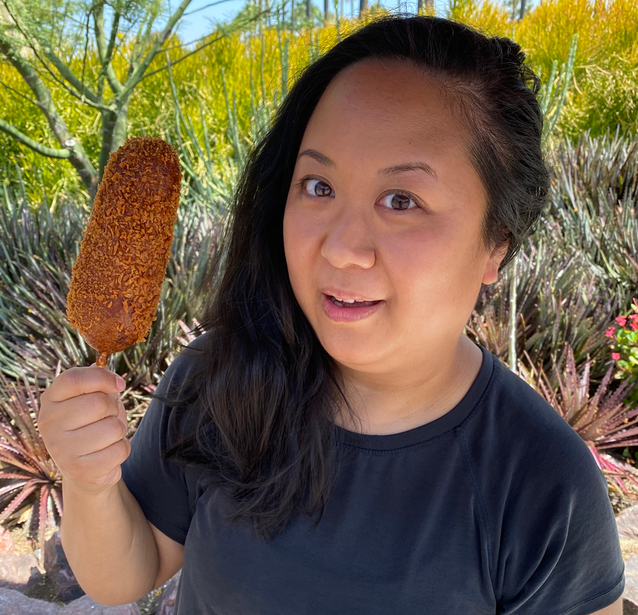Me holding up the corn dog next to my head for size comparison, it&#x27;s almost the same length