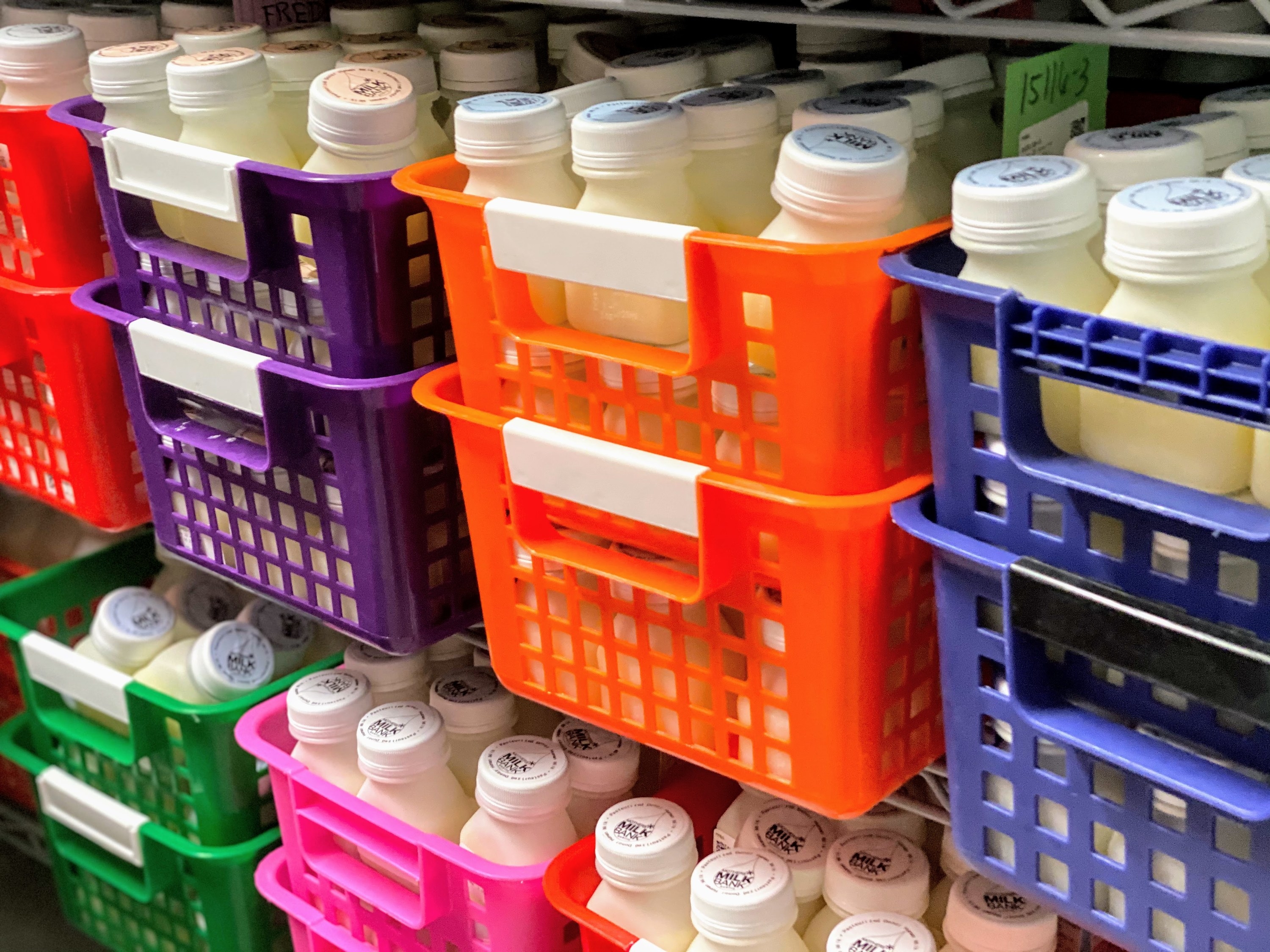 Colorful bins of bottled breast milk