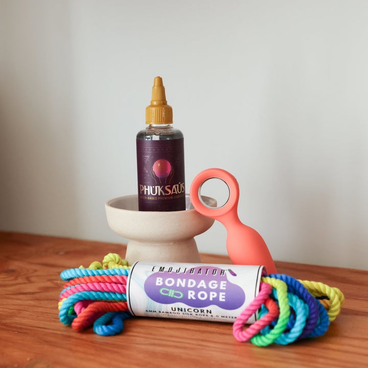 Bondage rope, vibrating plug and purple bottle of lubricant
