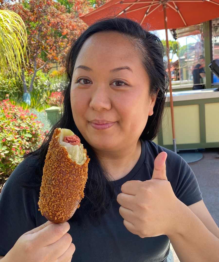 Me holding the corn dog and giving a thumbs-up