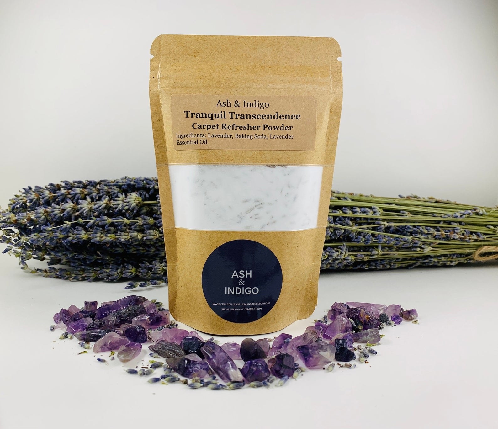 Bag of Ash and Indigo carpet freshener powder in front of a bundle of lavender