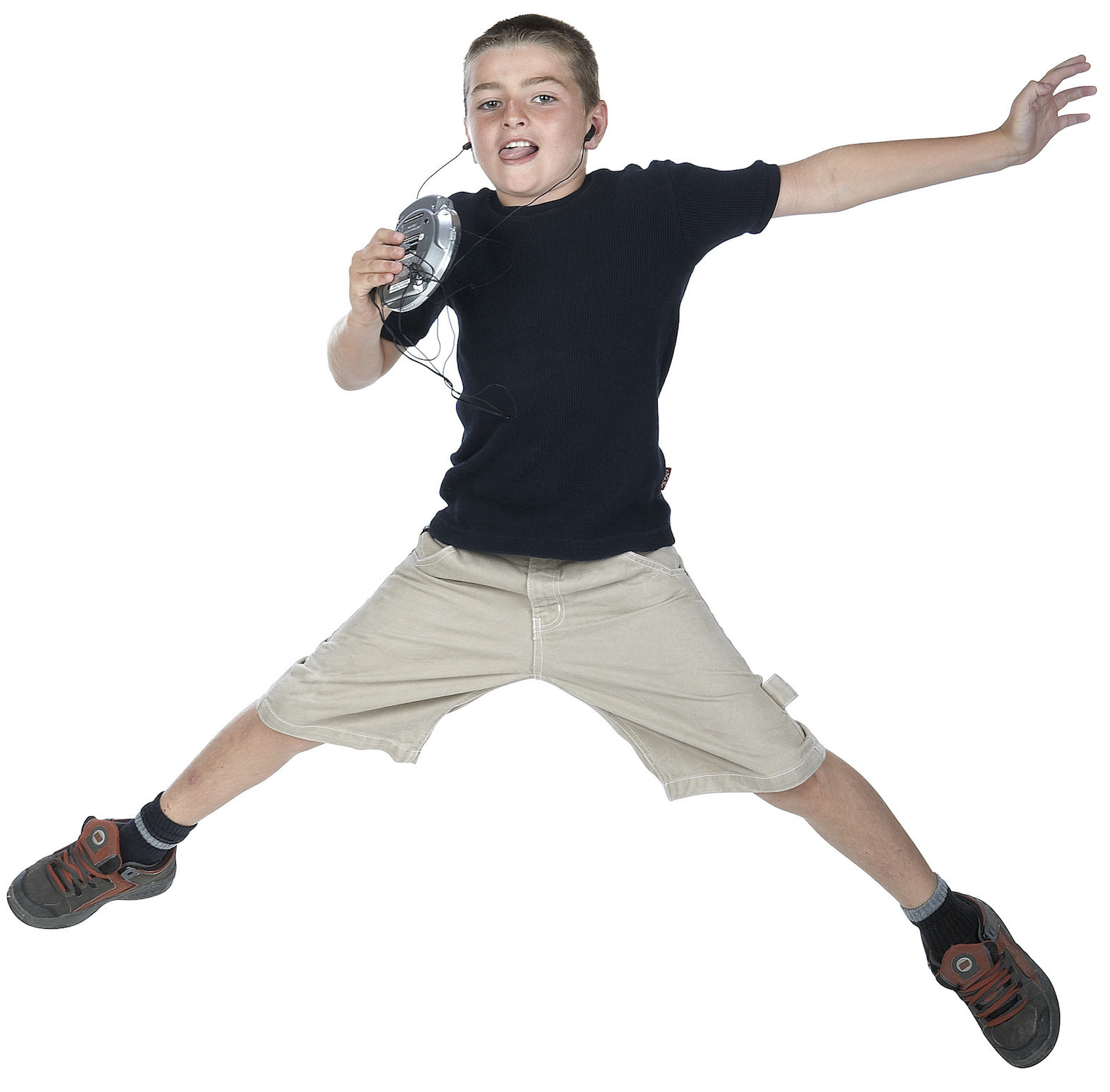 Stock image of kid jumping while listening to music on portable CD