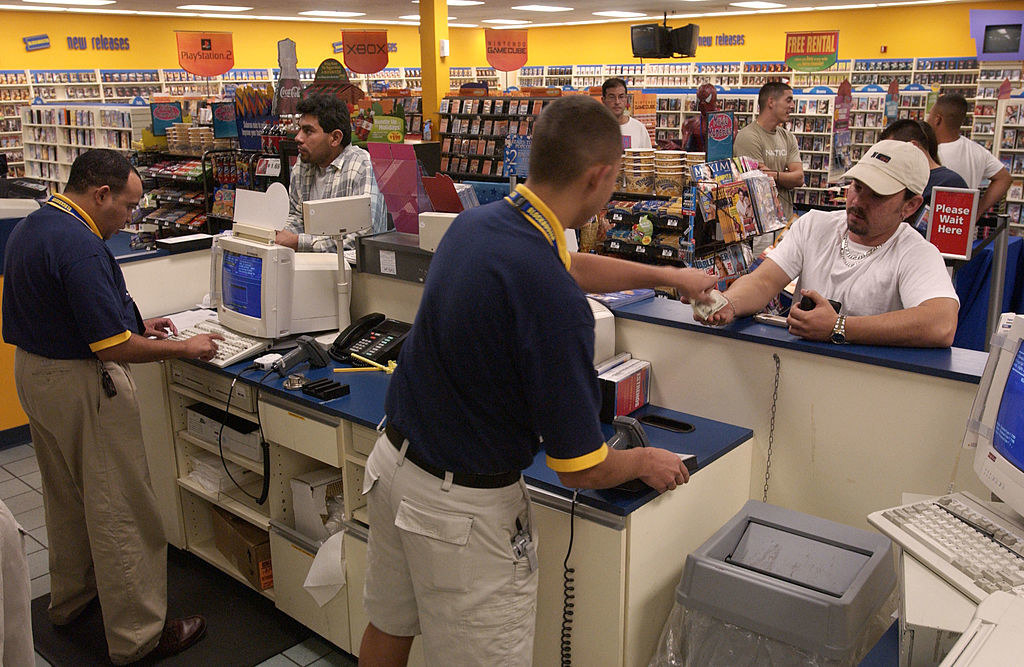 Cashiers helping customers at Blockbuster