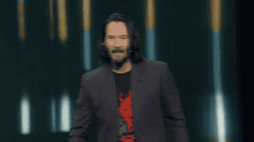 Keanu Reeves energetically saying check this out and pointing