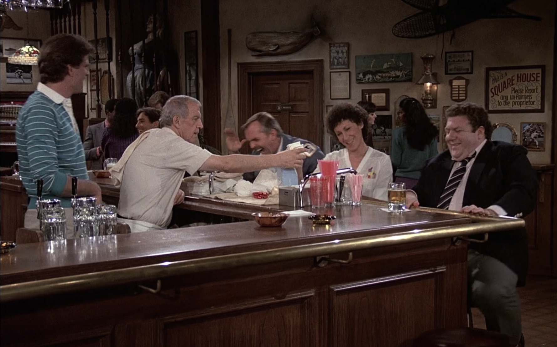 The &quot;Cheers&quot; gang sits around the bar, laughing