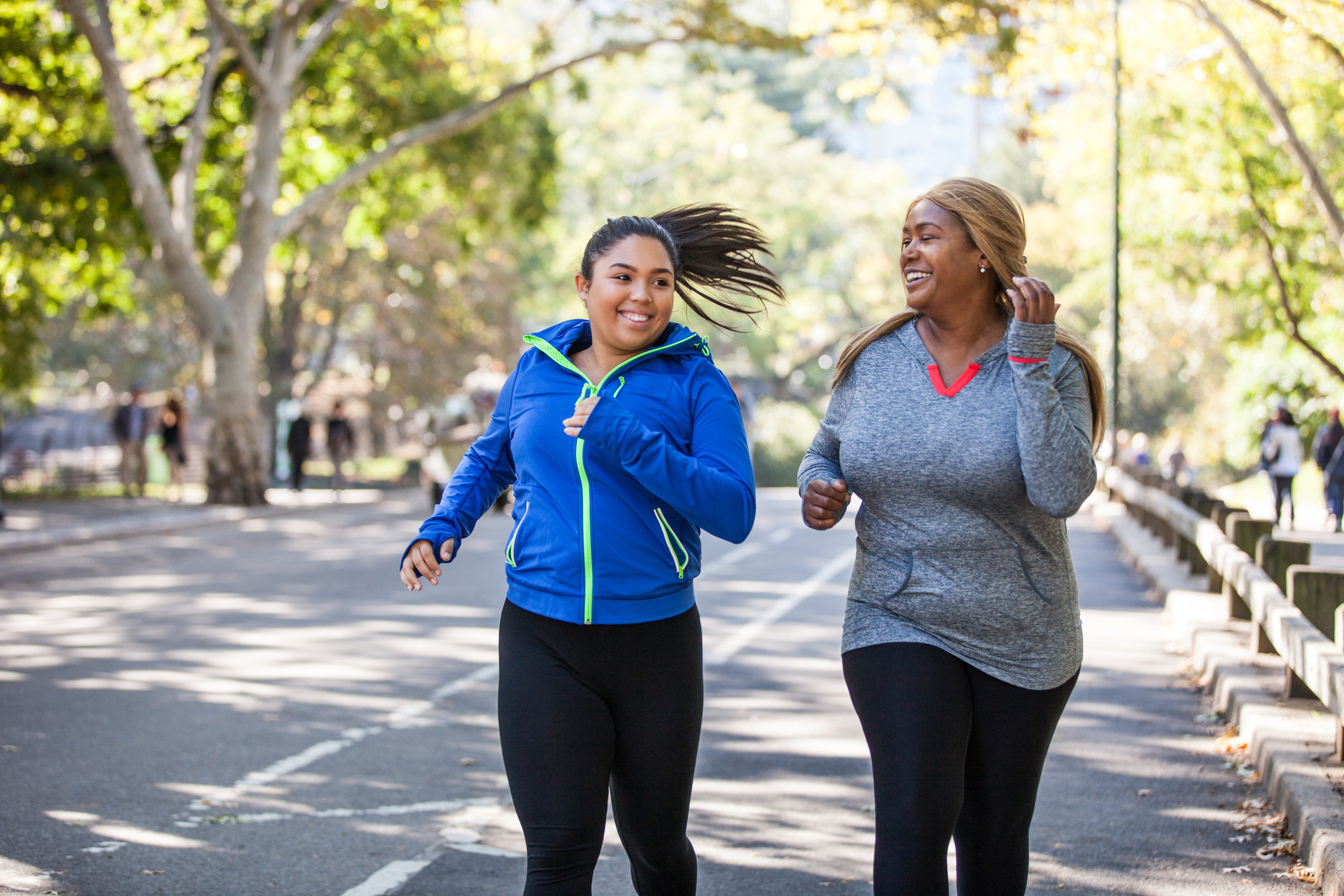 two women running on a road