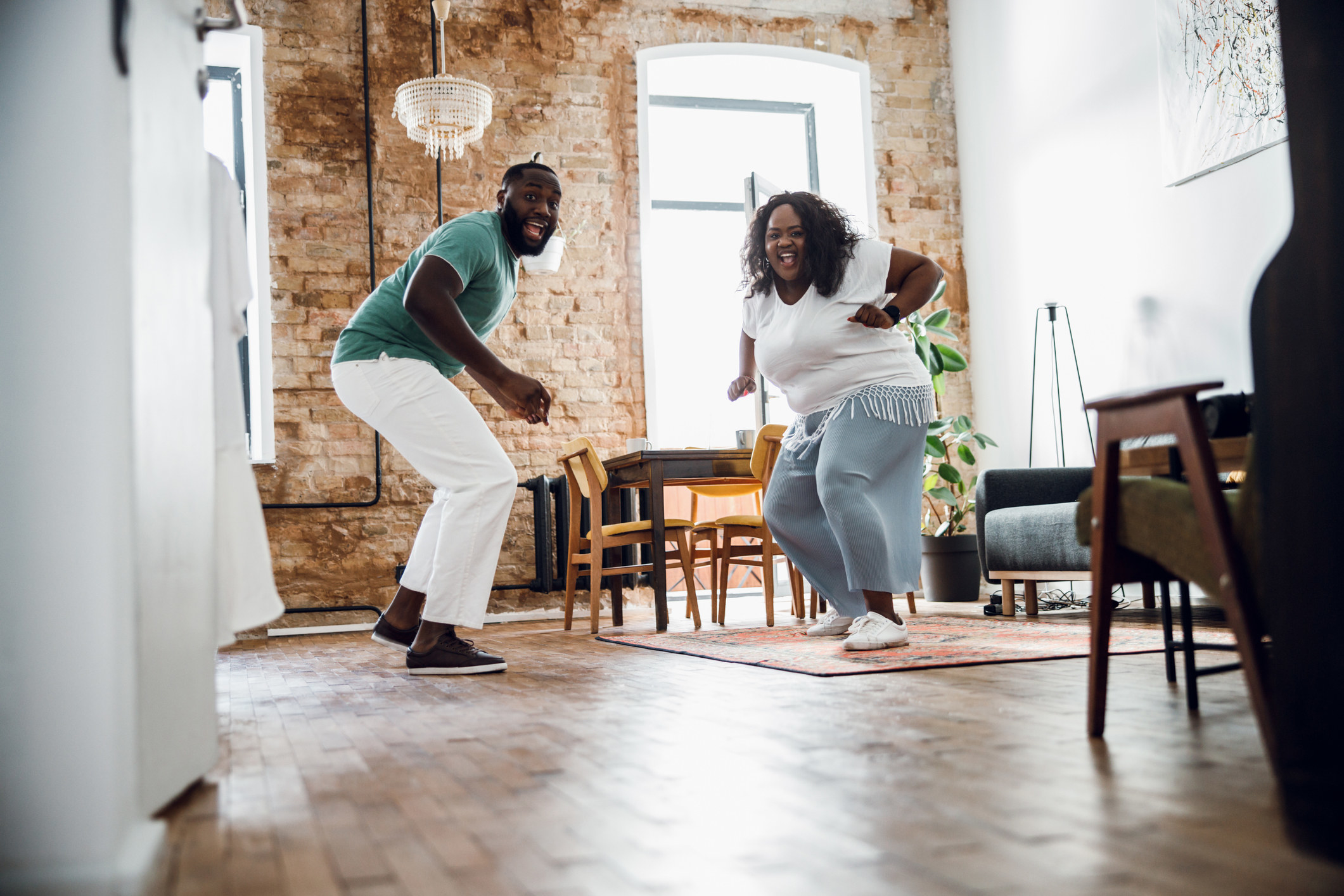 a man and a woman dancing in their house