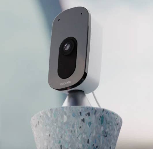 The petite indoor camera perched on a terrazzo pillar