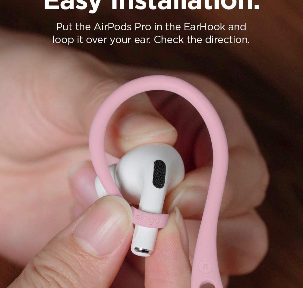 A person holding an AirPod with the hook on it