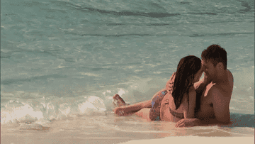 Bachelorette contestants kissing on the beach