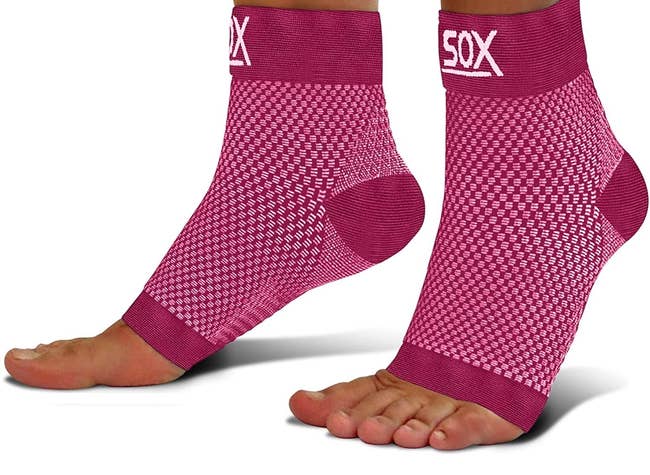 model wearing the pink compression socks, which show their toes