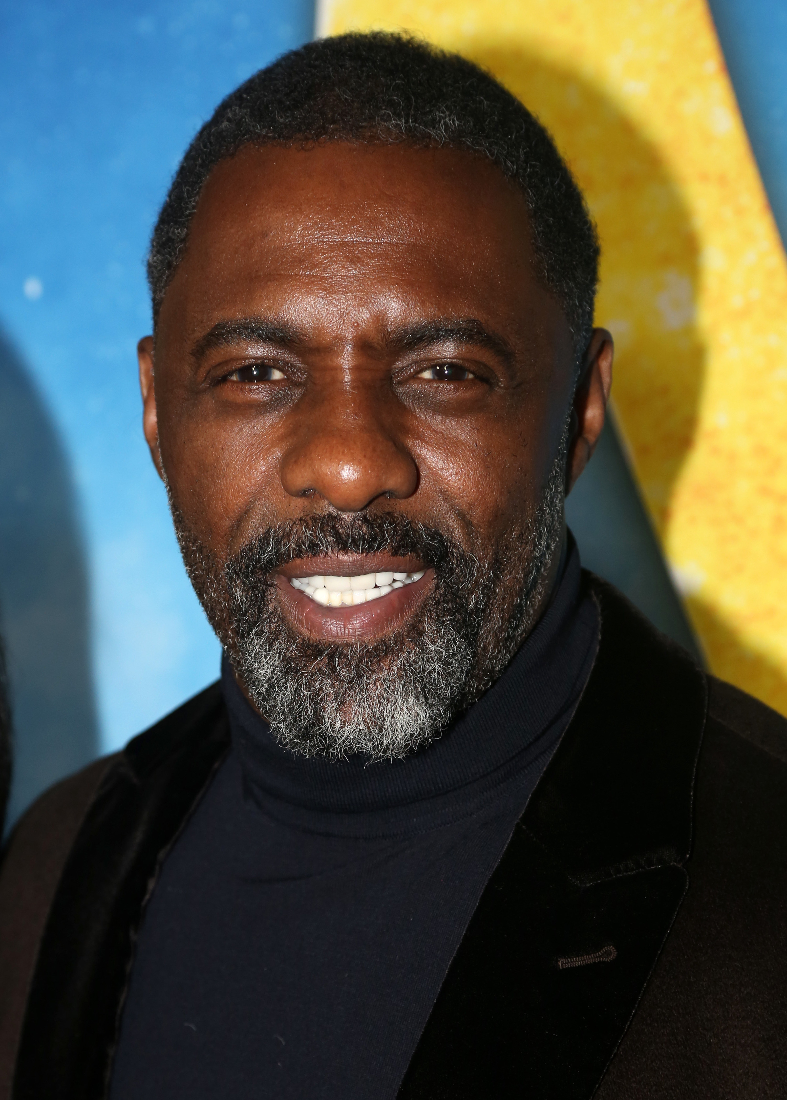 Idris Elba is pictured smiling at an event