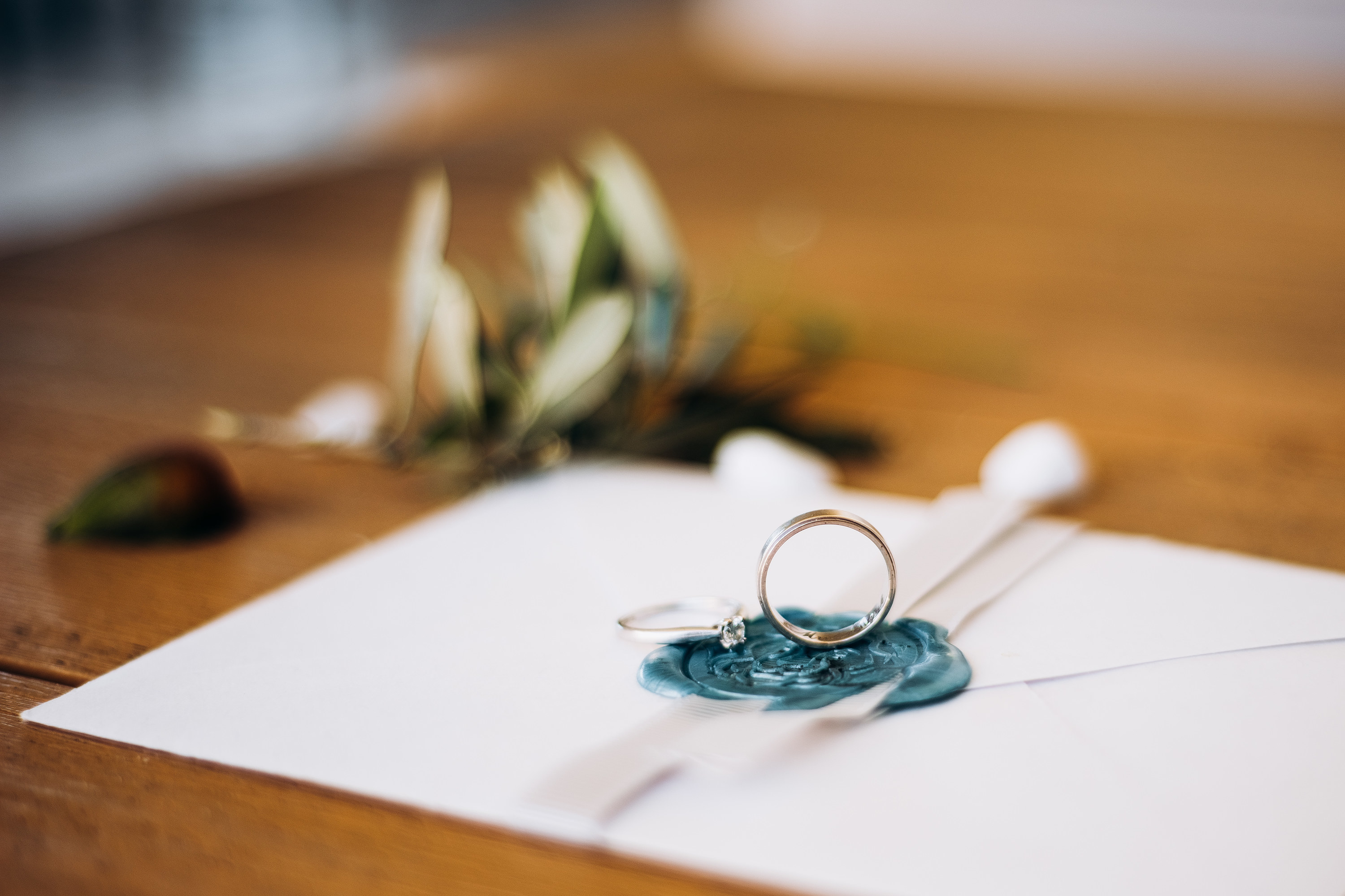 An invitation card with two rings laid on top