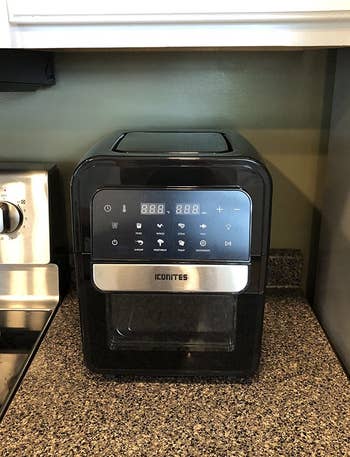 the compact 8-in-1 air fryer on a reviewer's kitchen counter