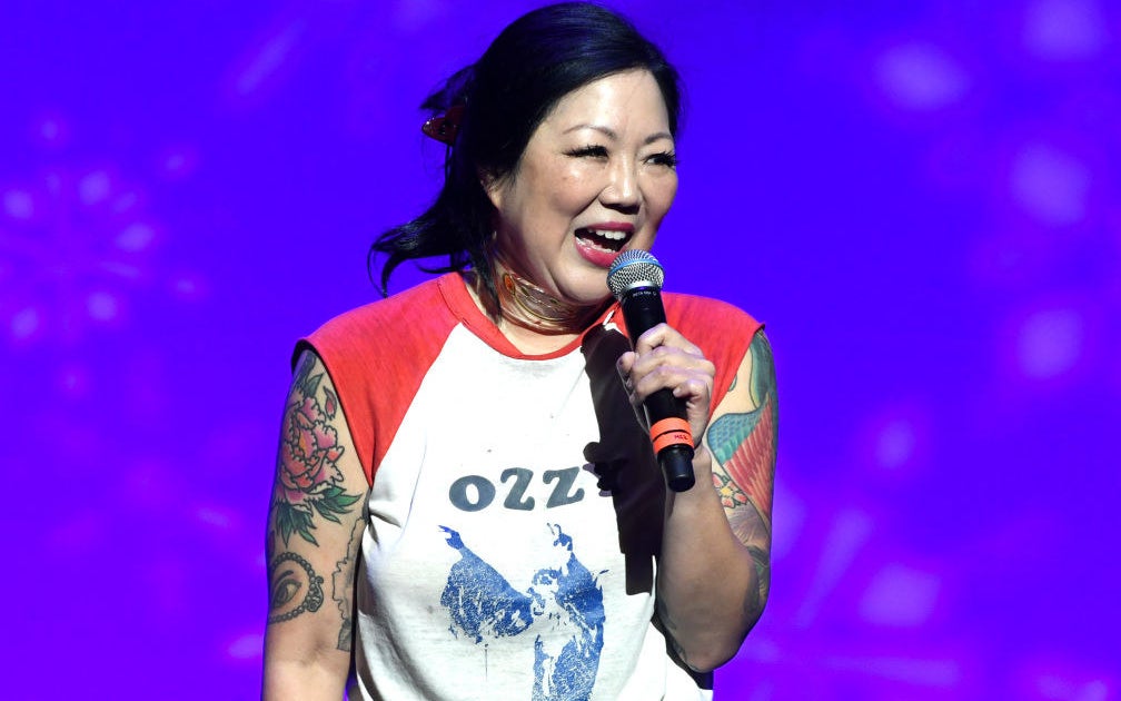Cho performing on stage, with tattoos on display