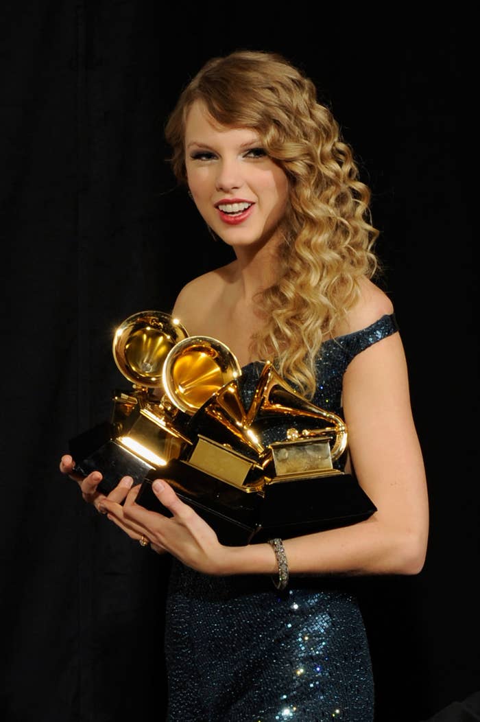 Taylor holding multiple Grammys
