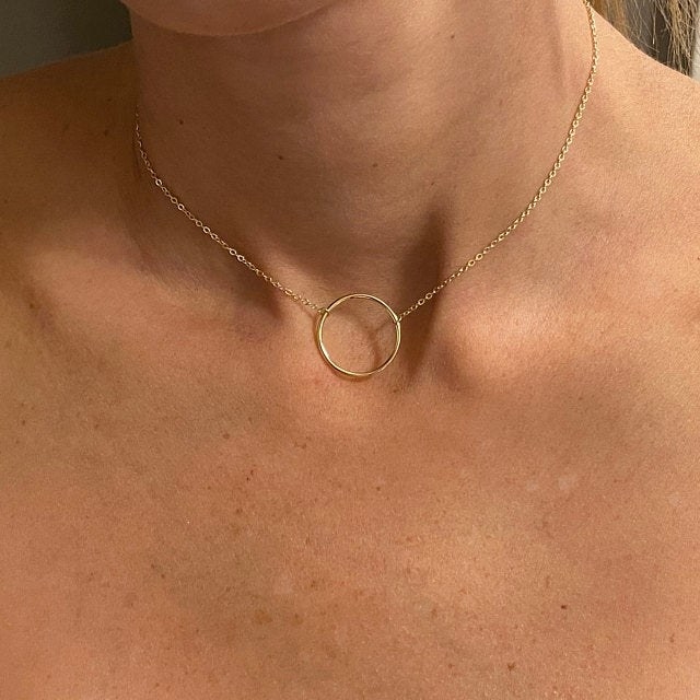 Woman wearing goldtone o-ring necklace
