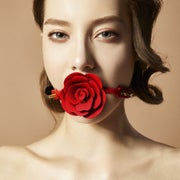 Model wearing red rose ball gag