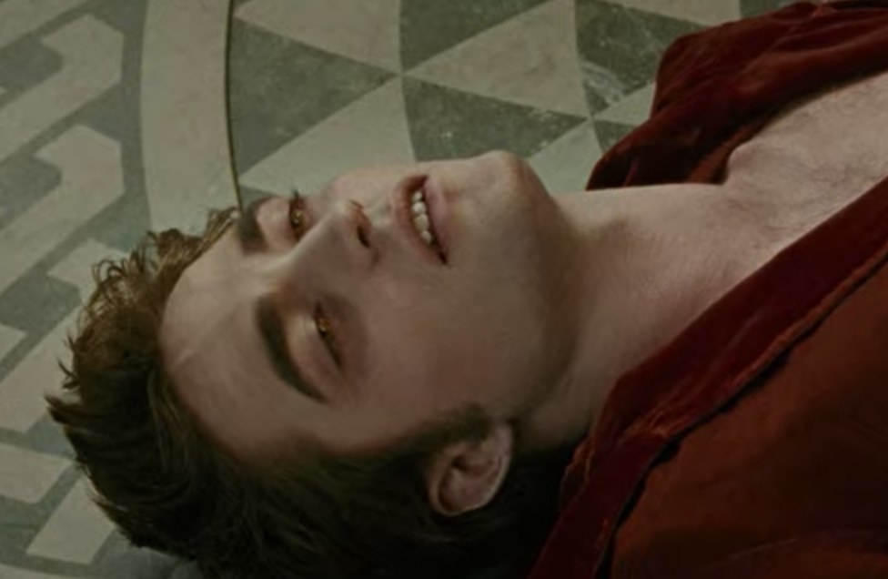 Edward lying on the floor with pain in his eyes