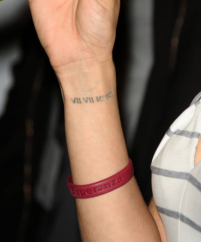 Someone shows off a tattoo on their wrist of Roman numerals indicating a date