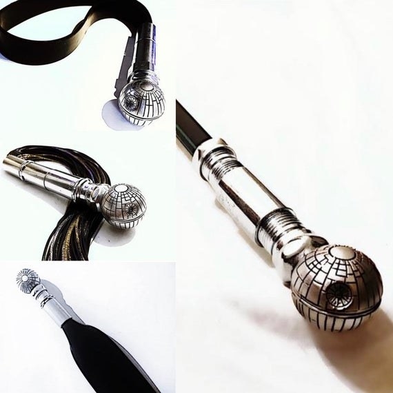 Black and silvertone cane, paddle, flogger and spanking strap with death star handle