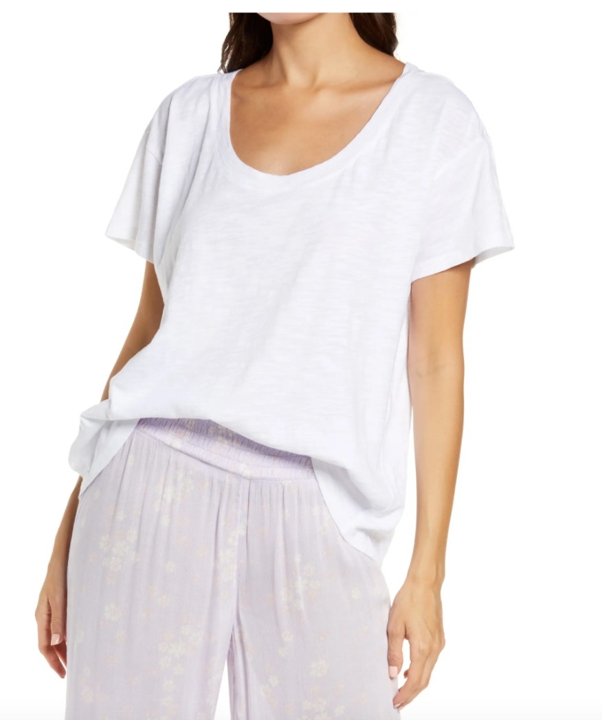 Model wearing a white tee shirt with purple pants