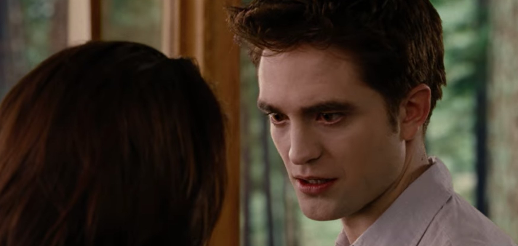 Edward furrows his brows angrily as he looks down at Bella.