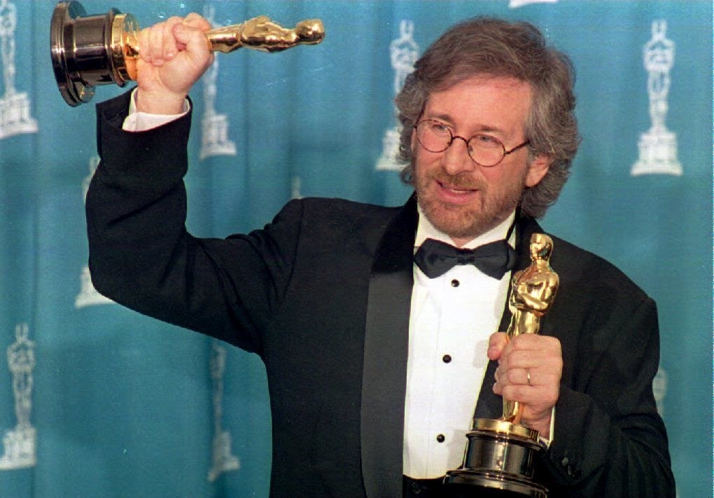 Steven Spielberg holding two Oscars
