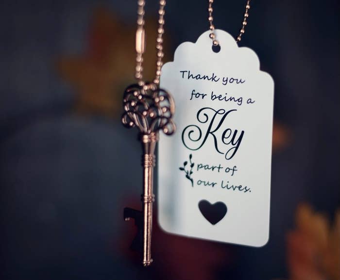 Reviewer photo of the key and the tag that says "Thank you for being a key part of our lives"