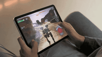 Hands playing a game on an iPad