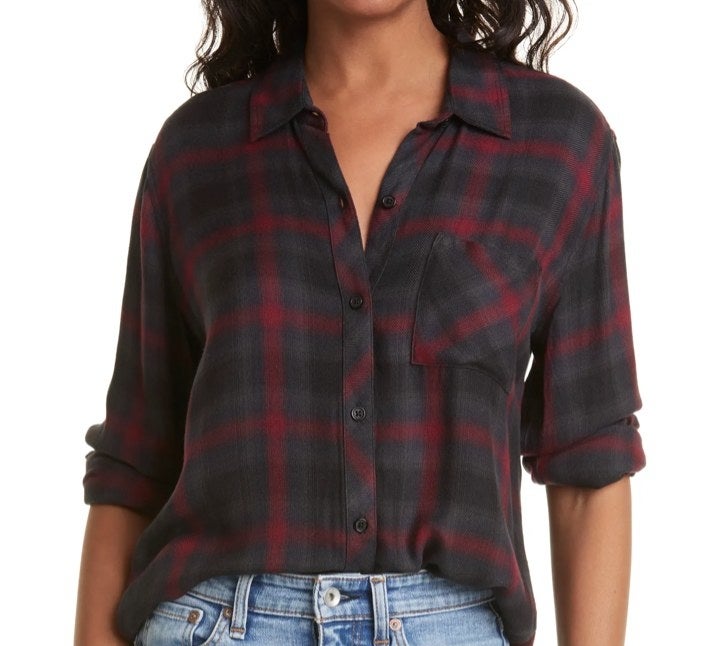 Model wearing a red button down with jeans