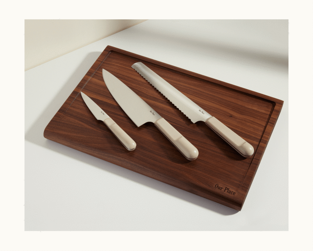 the knife trio on a dark wood cutting board