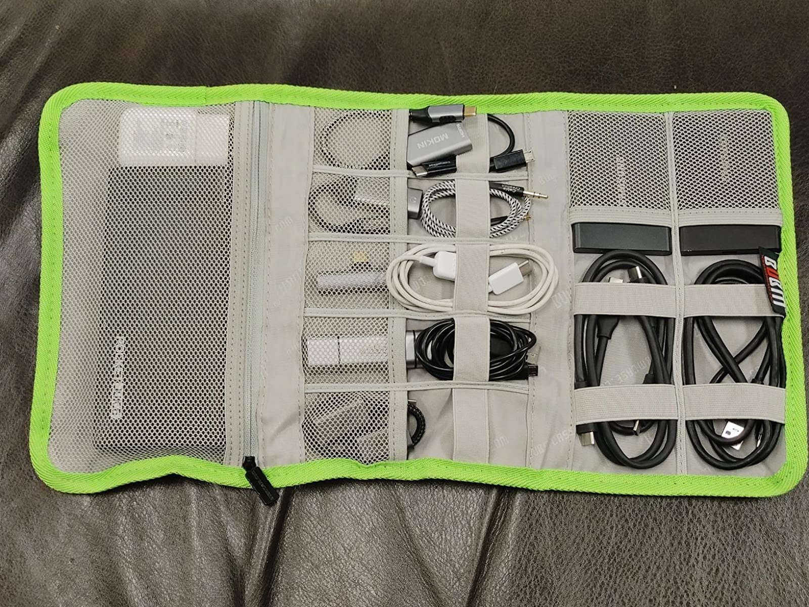 reviewer&#x27;s travel organizer filled with cords, chargers, and batteries