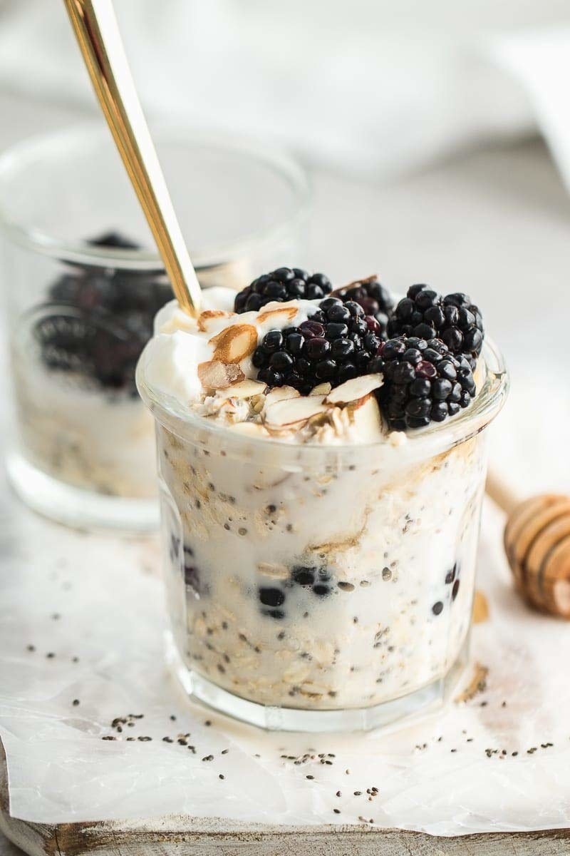 A jar of oats topped with blackberries and chopped almonds