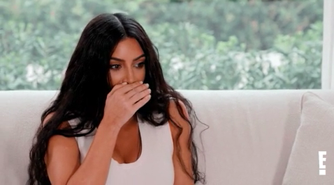 Kim Kardashian covering her mouth in shock